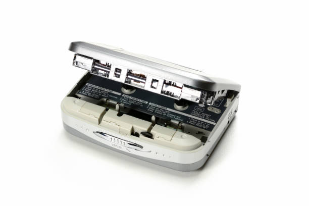 istock Vintage portable audio tape compact cassette player with lid open and inserted cassette, gray device on white background 1098033530