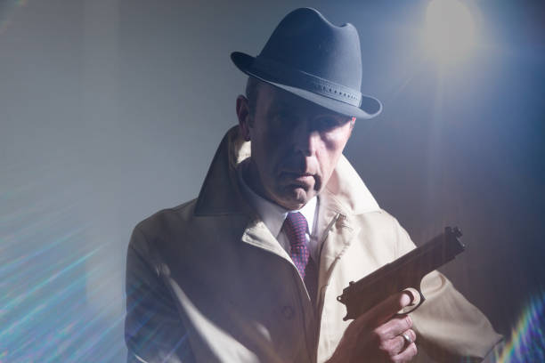 istock Old-fashioned gangster wearing fedora hat with handgun 1098034224