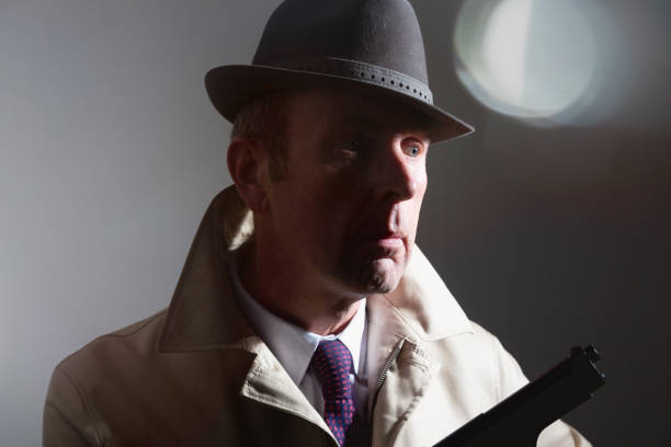 istock Old-fashioned gangster wearing fedora hat with handgun 1098034230