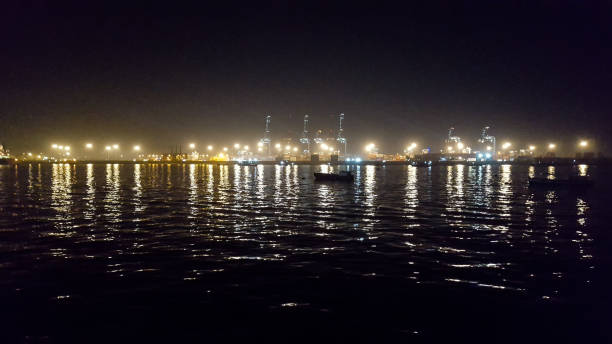lights reflection in the the water at night at Karachi port stock photo