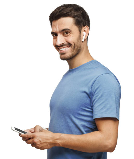 istock Young man looking and smiling at the camera, using mobile phone, isolated on white background 1098036042