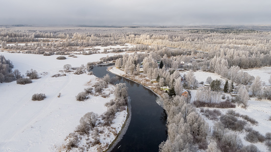 Drone point view, aerial view over the landscape, frost covered landscape, very cold morning. frost covered forest, airy view of the landscape - forest, river. drone photography