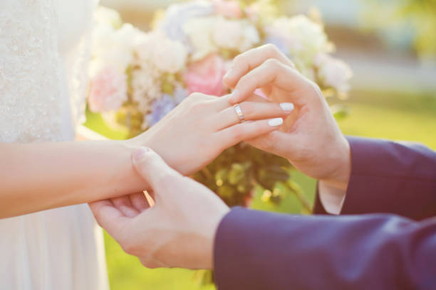 istock Bride and groom exchanging rings 1098036688