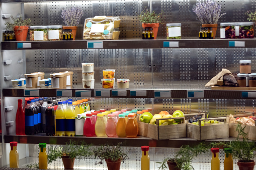 Assortment of organic juices on refrigerator shelfs