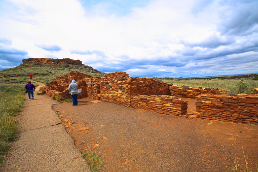 Flagstaff, Arizona, USA - May 19, 2011:  Native american ruins is a popular tourist destination.
Visitors explore indian Pueblo In Wupatki National Monument.