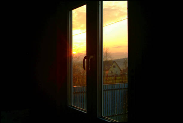 istock sunset through the Windows in a wooden house 1098052728