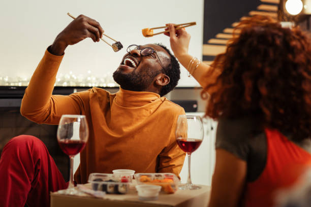 빠른 배달 후 초밥 집에서 식사 하는 동안 재미 있는 쌍 - sushi 뉴스 사진 이미지