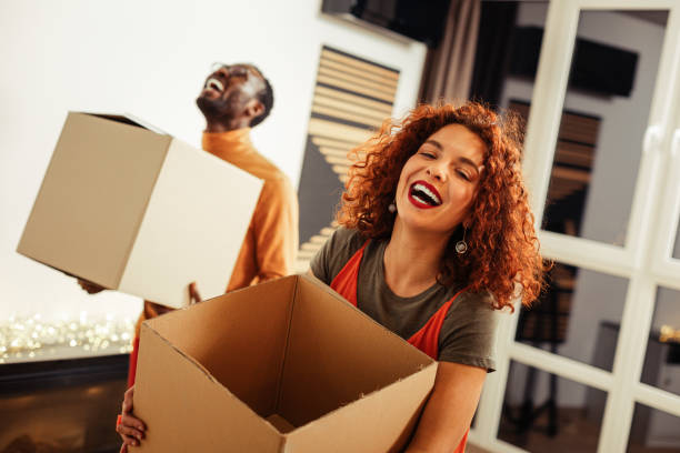 istock Couple laughing out loud while caring boxes with their clothes 1098053188