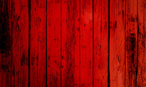 Old wooden door with flakey paint in red
