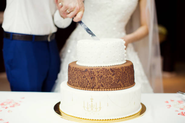 istock bride and groom cut wedding cake 1098057994