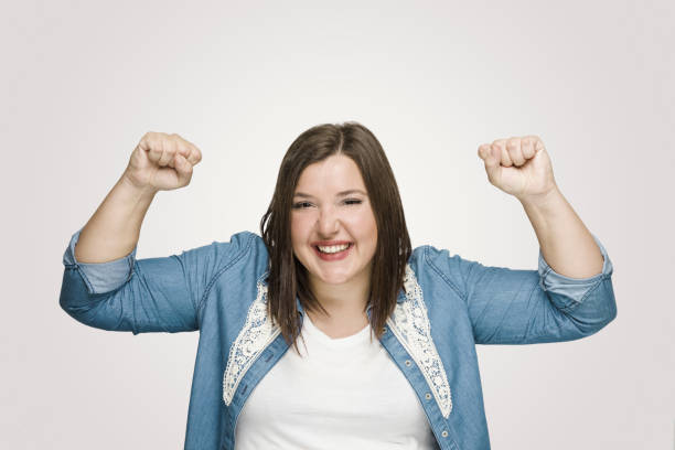 istock Excited Young Women Shaking Fists 1098061496