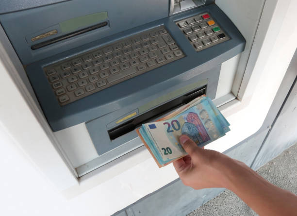 istock atm machine and european money banknotes 1098062720