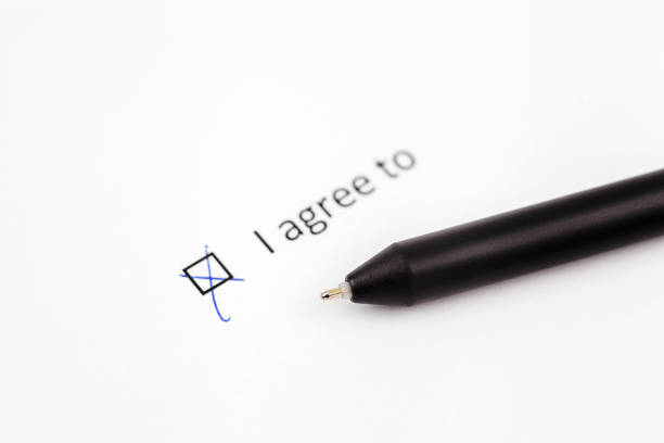 istock I agree to - checkbox with a check mark on white paper with pen. Checklist concept 1098065214