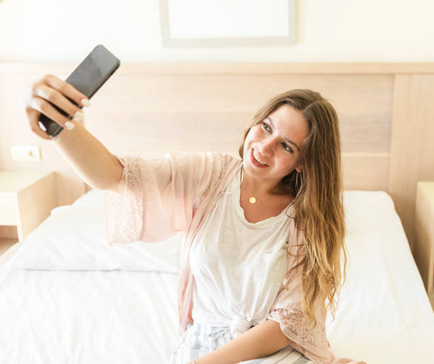 istock Woman taking selfie in bed 1098067260