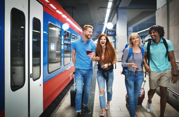 istock Group of young adults boarding a train. 1098067618
