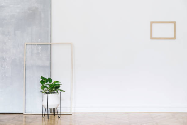 Modern and bright nordic living room with design sofa and furniture on the grey wall. Brown wooden parquet. Concept of minimalistic interior. contemporáneo nórdico, de espacio de trabajo, gris, blanco, puertas, living, sillón, piano, lujo, resumen, diseño de interiores, sala de estar, minimalismo, fondo, estilo, casa, habitación, espacio, diseño, interior, verde, terciopelo, silla, sofá,