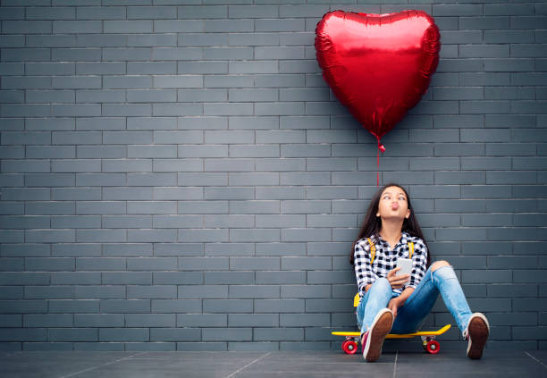istock Girl with heart shape balloon 1098081408