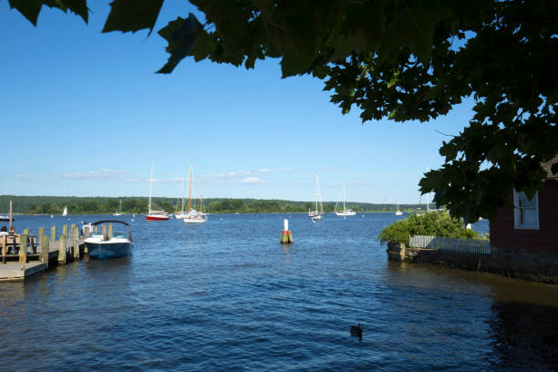 Boats in Essex Harbor on the Connecticut River in summertime. ESSEX, CONNECTICUT, USA - June 19, 2018: The boat launch at Essex Harbor on the Connecticut River is picturesque on a summer day. channel marker stock pictures, royalty-free photos & images