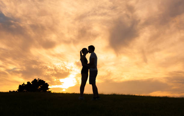 istock Couple kissing at sunset 1098082360