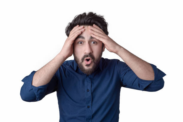 Portrait of young man with shocked facial expression stock photo