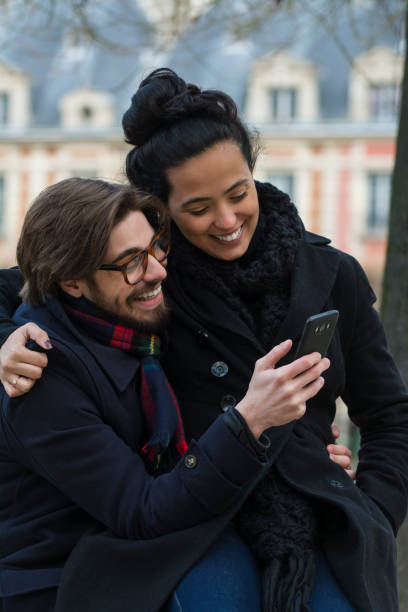 istock Couple watching at a smart phone and laughing 1098088902