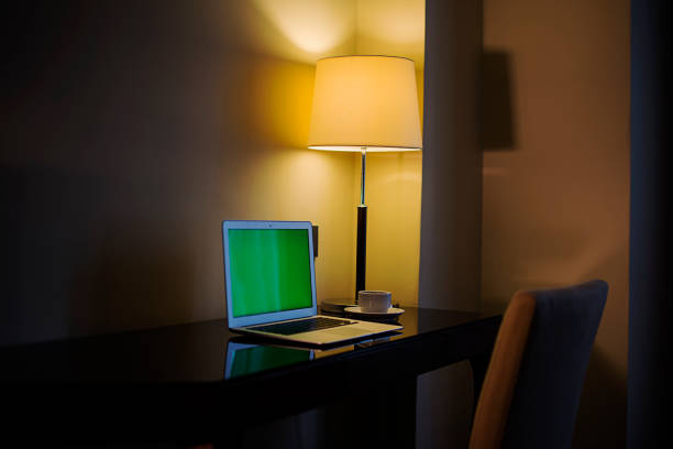 istock Laptop with copy space green screen in hotel room 1098089660