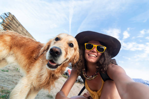 istock Woman With Dog in the beach 1098093308