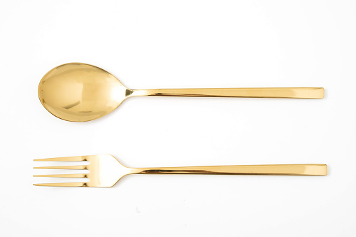 golden spoon and fork isolated on a white background