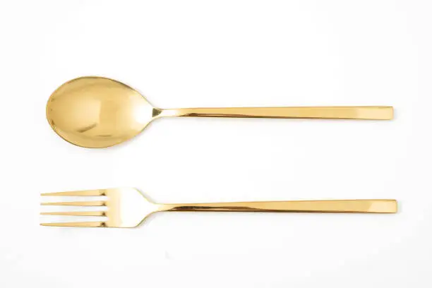 golden spoon and fork isolated on a white background