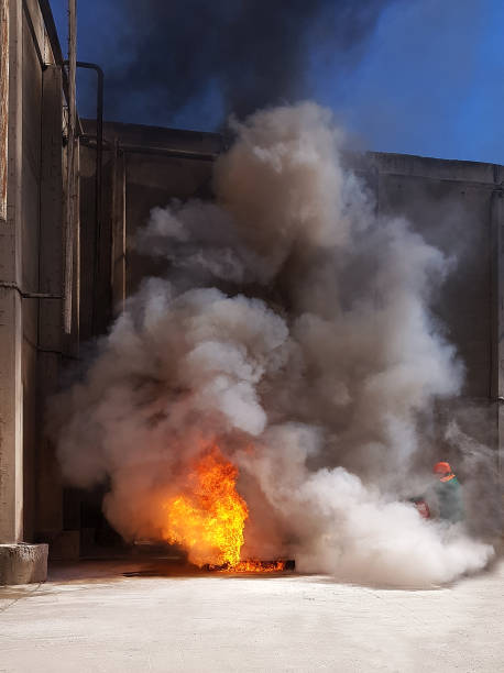 istock fireman extinguishes the fire with smoke. Firefighting exercises with fire extinguishing. 1098100946