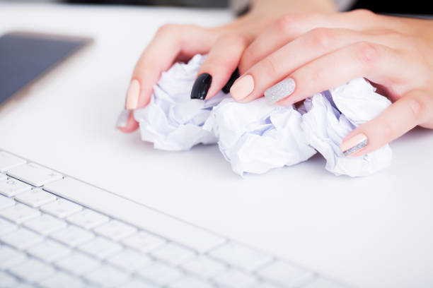 istock Stressed business woman imploring for help, holding a cardboard with the message Help . Focus is on the cardboard 1098110770