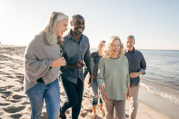 istock Active seniors walking on the beach 1098111698