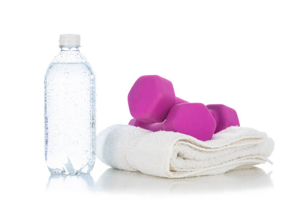 istock A clear plastic water bottle with hand weights on white towel on a white background 1098111814