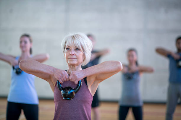 istock Senior woman with kettle bell 1098113728