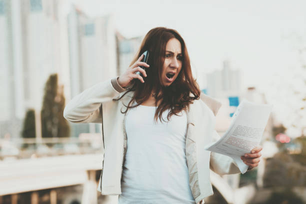 istock Girl on phone, papers with buildings on background 1098113816