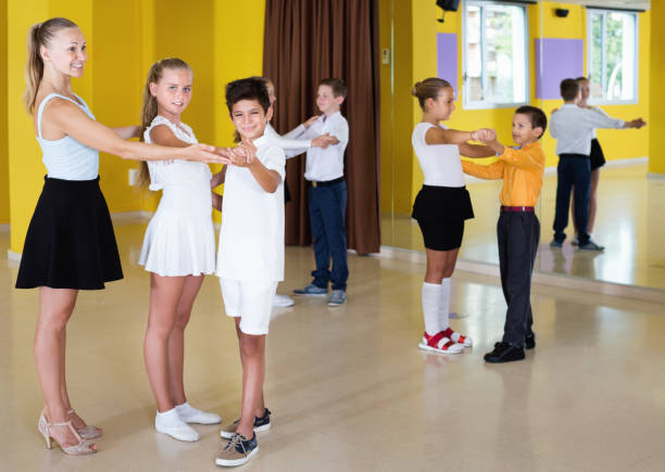 istock Little boys and girls having dancing class in classroom 1098116380