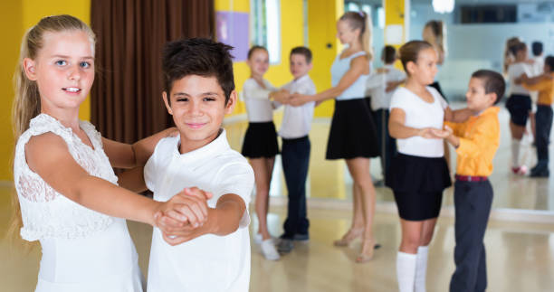 istock Little boys and girls having dancing class in classroom 1098116402