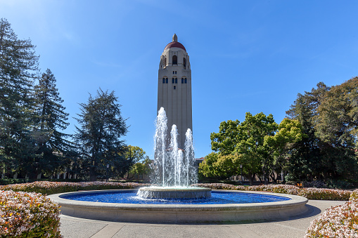 Stanford, California, USA - March 29, 2018: Fountain and Hoover Tower on the campus of Stanford University in Stanford, California.