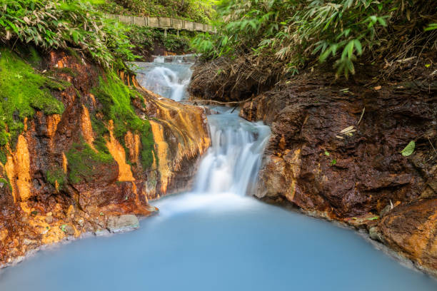 oyunuma natural footbath, a shallow stream that flows from oyunuma pond through hell valley (jigokudani) with natural hot water at noboribetsu, hokkaido japan - hokkaido japan stream forest imagens e fotografias de stock