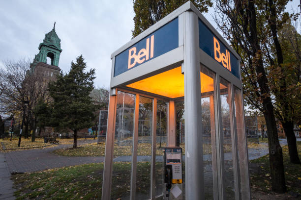 Bell Canada Payphone in Montreal in the evening. Bell Canada is one of the main phone booth providers and telephone carrier in the country Picture of a Bell Canada Phone booth in Montreal, Quebec, Canada. Bell Canada is a Canadian telecommunications company headquartered in Quebec. blue pay phone stock pictures, royalty-free photos & images