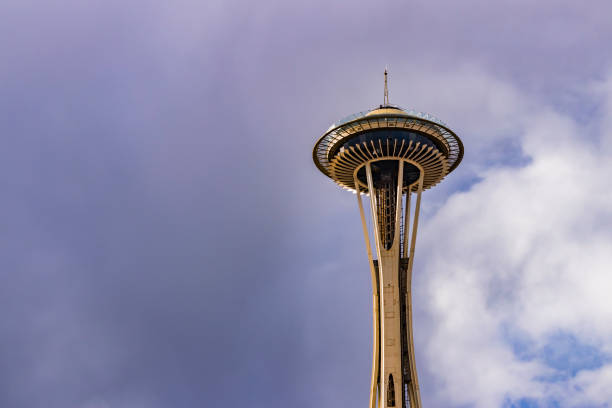 Seattle, United States of America - July 26, 2014: The Space Needle in Seattle, Washington State, USA, offers to tourists, at the Observation Deck and at the SkyCity rotating Restaurant, an espectacular view of the city's downtown, Olimpic and Cascade mountains, Mount Rainier and Mount Baker Volcanoes, Elliott Bay, Puget Sound and the Pacific Ocean with the islands of the area. In mid-summer's clear day, like in this picture of July 26th, 2104, people can take advantage of the view because during the rest of the year most of the days are rainy and cloudy,