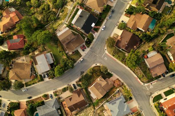 Birds Eye View of Southern California Suburban Sprawl - Drone Photo Top down view of Los Angeles Suburb, La Canada, looking down at rooftops, pools, backyards, streets and neighborhoods. solar panels on the roof of building in a city stock pictures, royalty-free photos & images