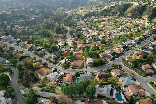 Birds Eye View of Southern California Suburban Sprawl - Drone Photo Top down view of Los Angeles Suburb, La Canada, looking down at rooftops, pools, backyards, streets and neighborhoods. solar panels on the roof of building in a city stock pictures, royalty-free photos & images