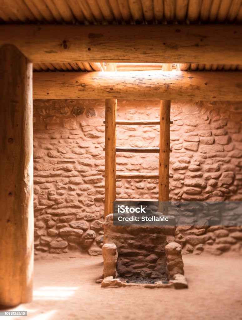 Underground Kiva with access ladder in a Native American Pueblo in New Mexico, USA. Kachina Doll Stock Photo