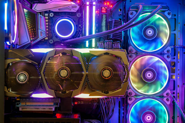 Inside Desktop PC Gaming and Cooling Fan CPU with multicolored LED RGB light show status on working mode Close-up and inside Desktop PC Gaming and Cooling Fan CPU with multicolored LED RGB light show status on working mode, interior PC case technology background electric fan photos stock pictures, royalty-free photos & images