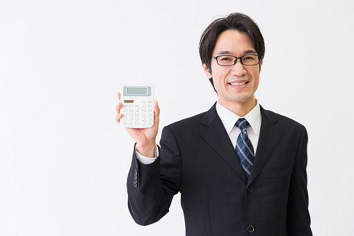 Asian middle age asian businessman having an electronic calculator