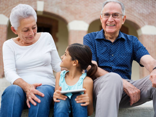 istock Granddaughter holding a digital tablet with grandparents 1098154018