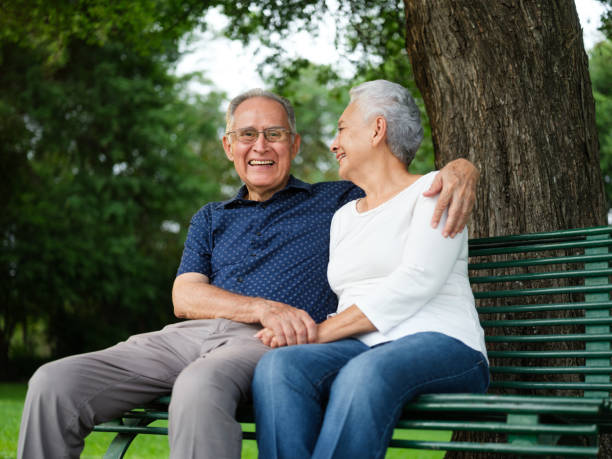 istock Senior couple sitting on a bench 1098154066