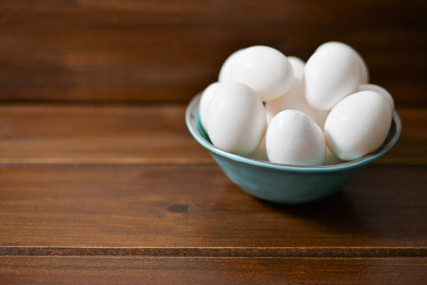 istock white eggs on wooden plate 1098162088
