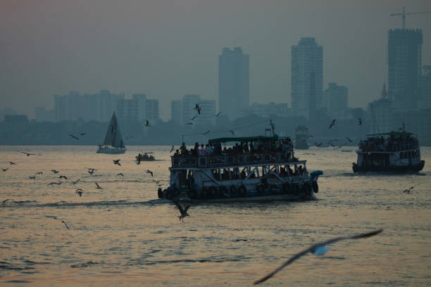 Mumbai MH India - November 19, 2016 : Taken this picture off the coast of Mumbai of the Mumbai skyline at a distant. Tried to capture the entire the skyline of Mumbai India in a cloudy sky.